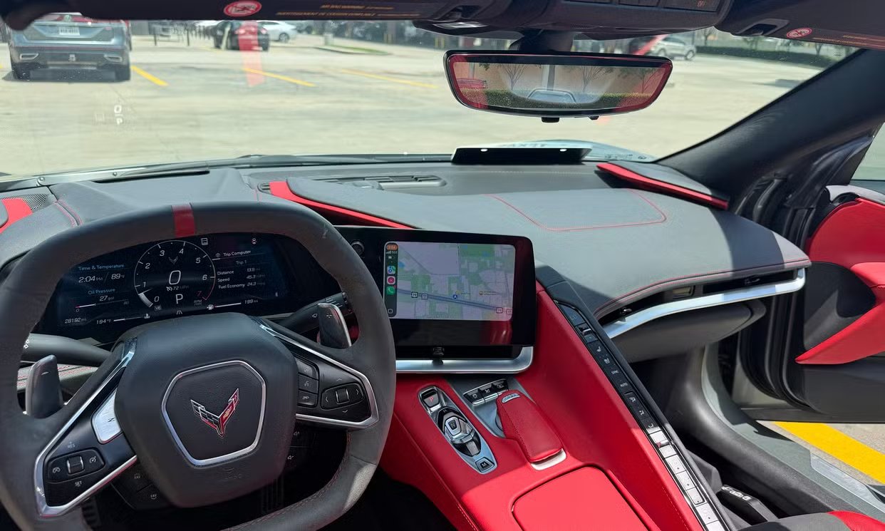 Driver-focused cockpit with red leather and digital gauge cluster